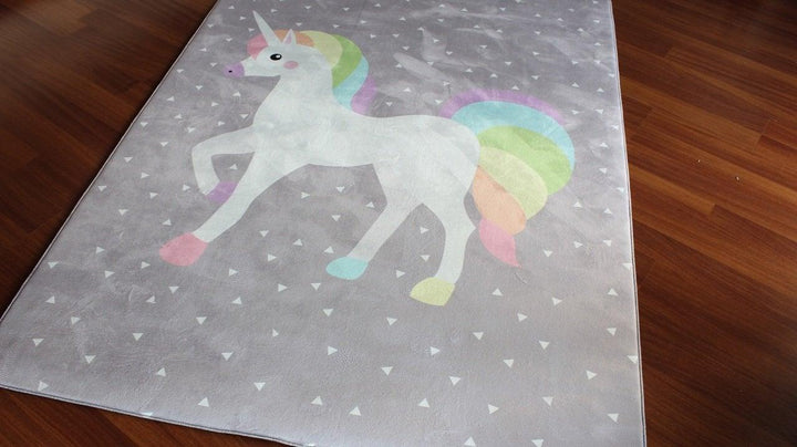 Cute unicorn children's carpet with pastel colors on a soft surface, perfect for decorating playrooms and nurseries.