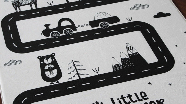 Children's carpet with playful road design featuring animals, cars, and mountains for kids' rooms.